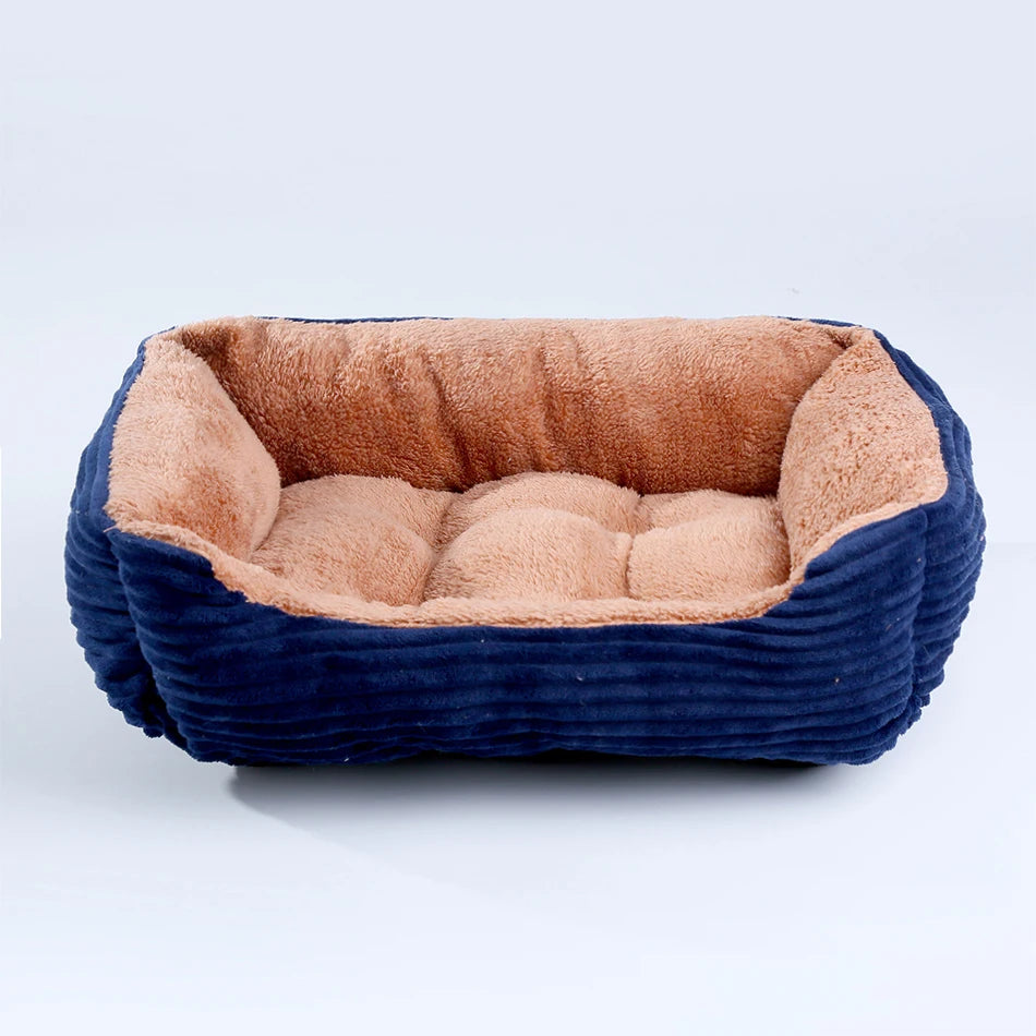 Pet bed with blue exterior and beige interior on a light gray background