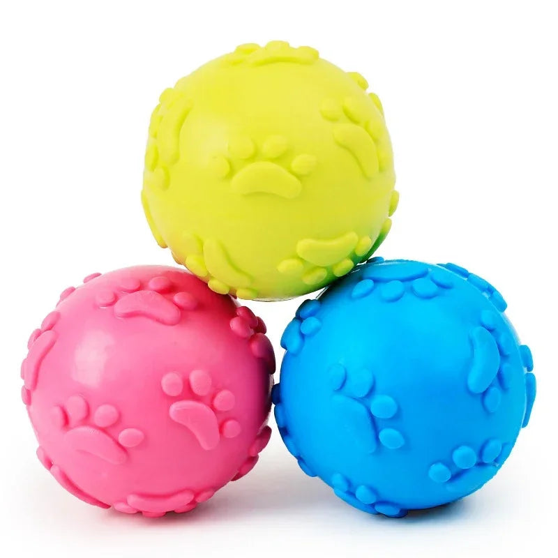 Three colorful textured balls (yellow, pink, blue) on a white background