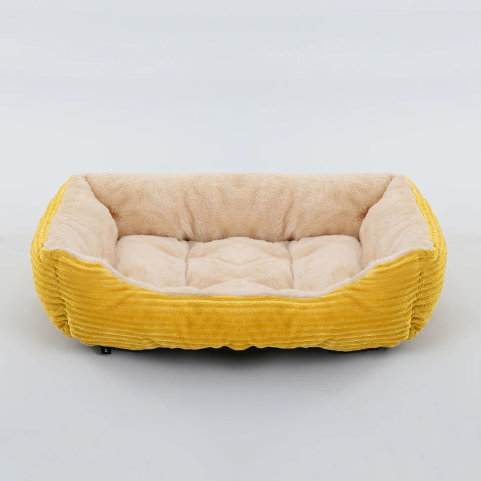 Pet bed with yellow exterior and beige interior on a light gray background