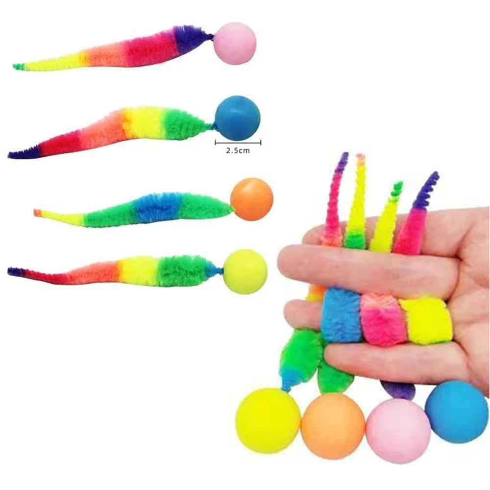 Colorful cat toys with fuzzy tails and ball ends held by a hand on a white background